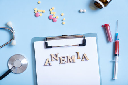 Anemia text with stethoscope, pills and syringe flat lay, top view.の写真素材