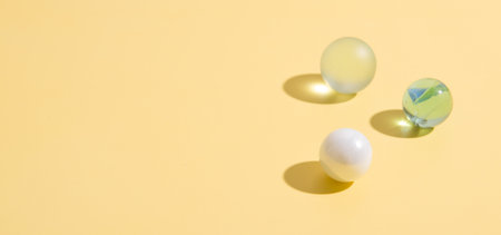 Glass balls and hard shadows - abstract background in banner format.の写真素材