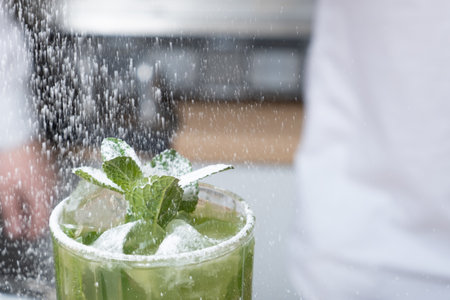 Preparation of a mojito cocktail by a bartender in a cafe. Summer cold drinkの写真素材
