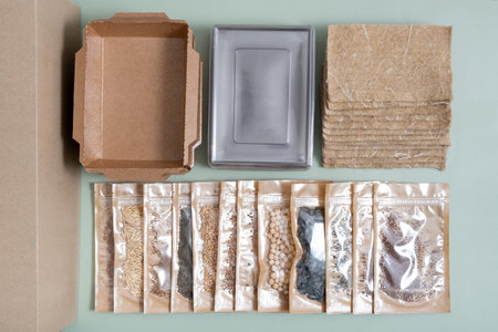 Set for growing sprouts from seeds. Seeds, linen mats, boxes and lids flat lay, top view.
