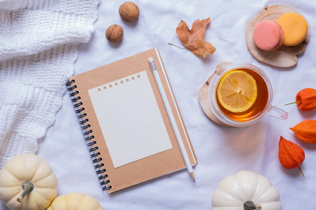Blank sheet of paper and autumn cozy decor top view. Copy space for autumn text.