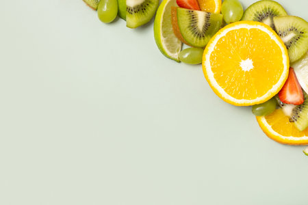 Citrus fruits and strawberries flat lay, top view. Summer layout on colored background.