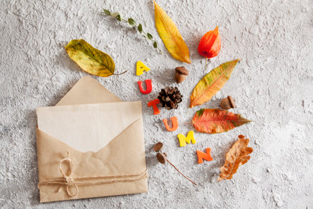 Top view of layout with word autumn, envelope mock up and fallen leaves. Autumn conceptの写真素材