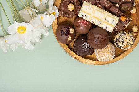 Wooden plate with healthy craft natural candies and mini chocolates. Sweet food, healthy dessert.