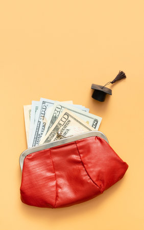 Graduated cap with dollars cash in wallet. Grant for education, back to school allowance concept.の写真素材