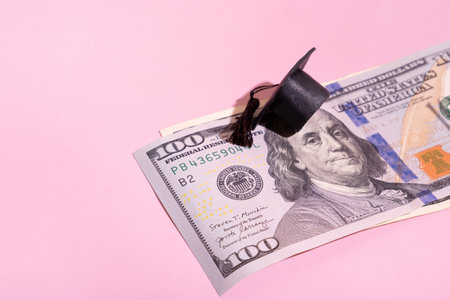 Graduated cap with dollars. Grant for education, back to school allowance concept.の写真素材