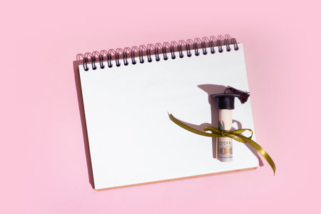 Graduated cap with dollars and blank note. Back to school allowance, grant for education concept.の写真素材