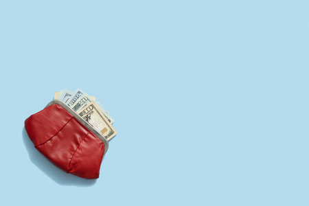 Wallet with dollars top view, flat lay. Copy space on blue backgroundの写真素材