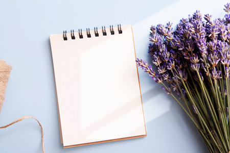Blank sheet of flat lay notebook with lavender, candle, twine. Write your messageの写真素材