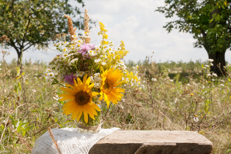 A bouquet of wild flowers in a field on a background of nature. Cottage life, summer conceptの写真素材