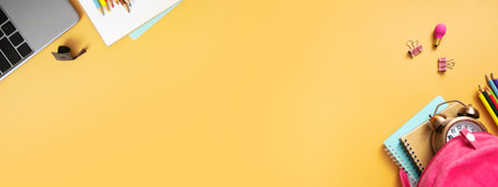 Notebooks, teddy bear and stationary on colored background. copyspace. Kids work space top view, flat lay. online learning concept.の写真素材