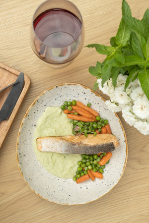 Salmon fillet on cauliflower puree with red wine top view, flat lay.の写真素材