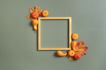 Gold frame with decorative pumpkin and copy space. Autumn minimalist aesthetic concept.の写真素材