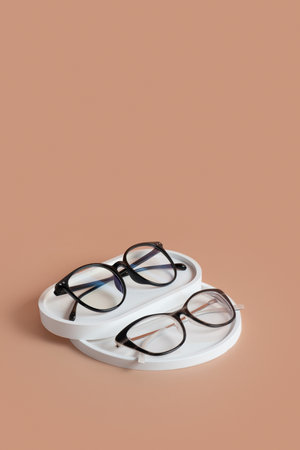Gypsum elements with eyeglasses on colored background. Optical store, vision test, stylish glasses concept top view, flat lay.の写真素材