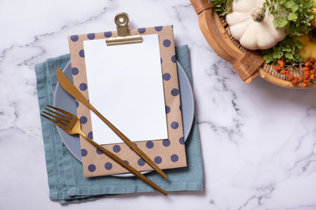 Autumn flat lay with blank tablet with cutlery and decorative pumpkins on marble background top view.の写真素材
