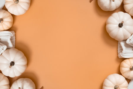 Autumn flat lay composition with pumpkins and sweater with space for text on orange background.の写真素材