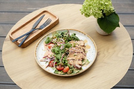 A plate with meat salad from veal on a wooden table.の写真素材