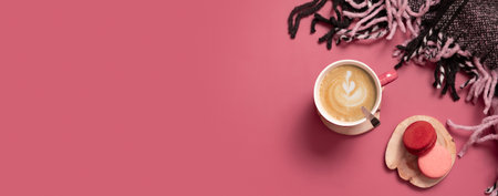 Autumn flat lay banner with cup of coffee latte, macaroons and plaid on dark pink background. Creative autumn, thanksgiving concept. Top view, copy space.の写真素材