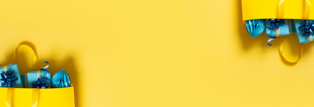 Christmas sale concept with shopping bag and gift boxes on color background flat lay.の写真素材