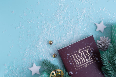 Holy bible and Christmas decorations with snow. Christian winter background