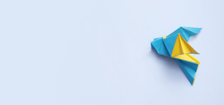 Yellow-blue paper doves on blue banner background top view. International Peace day conceptの写真素材