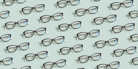 Glasses for vision on a green background. Optical store, vision test, stylish glasses concept. Banner with patternの写真素材