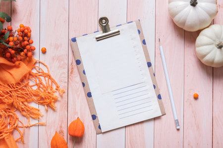 Blank sheet of paper and autumn cozy decor flat lay, top view. Copy space for autumn text.の写真素材