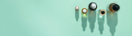 Cosmetic bottles of oil and serum with pipette with hard shadows mint background banner format copy spaceの写真素材