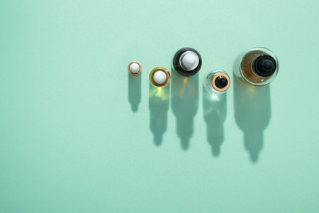 Cosmetic bottles of oil and serum with pipette with hard shadows mint background copy spaceの写真素材