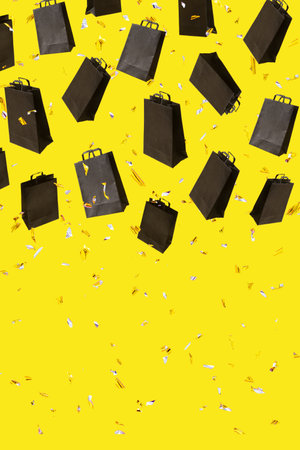 Pattern with black sale shopping bags are flying and sparkles on yellow background with copy space. Black Friday creative conceptの写真素材