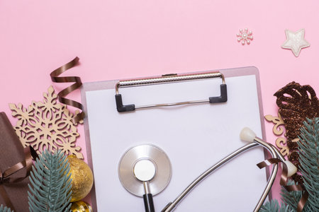 Doctor's stethoscope and XMAS decorations top view. Medical winter holidays Christmas New Year background with copy space.の写真素材