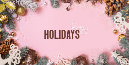 Happy Holidays greeting card with Xmas decoration on pink background. Noel. Flat lay. Banner.の写真素材