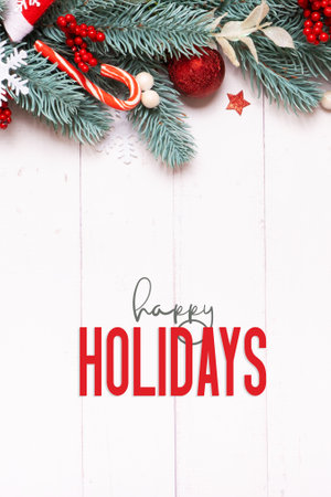 Happy holidays with winter holidays composition made from pine tree, stars and festive decorations top view. Xmas New year greeting card.の写真素材