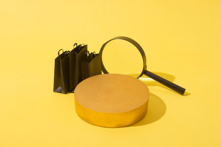 Empty mockup podium or pedestal and miniature black shopping bags and magnifire in black friday sale...