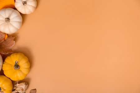 Autumn flat lay composition with pumpkins and fallen leaves and sweater with space for text.の写真素材