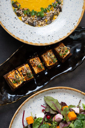 Sandwiches with pickled soft cheese and other dishes in plates. Delicious autumn dishes,の写真素材