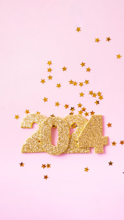 Numbers 2024 and stars on a pink background. Happy new year concept.の写真素材