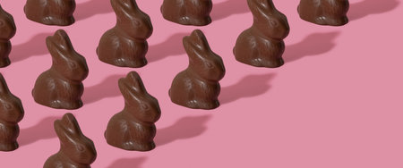 Chocolate rabbit pattern symbol to Easter holidays on a pink banner backgroundの写真素材