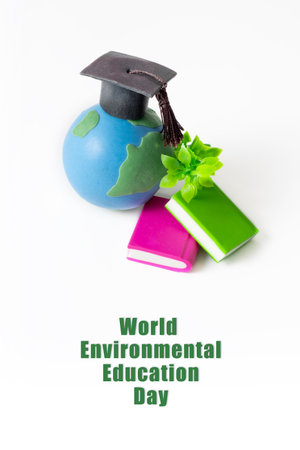 World Environmental Education Day text. Globe with green twig, graduated cap and books isolated on whiteの写真素材