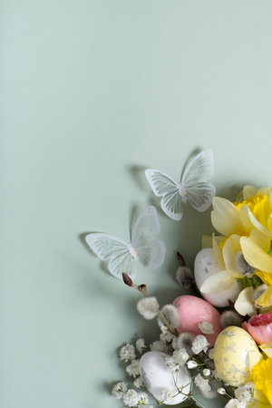 Daffodils, easter eggs and willow on green background. Easter greeting card template.の写真素材