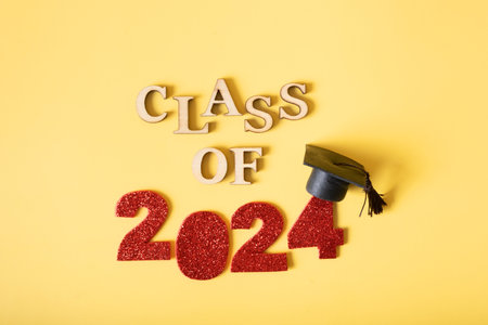 Class of 2024 concept. Red number 2024 with graduated cap and confetti top view.の写真素材