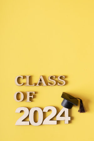 Class of 2024 text with graduated cap on yellow. Graduation holiday conceptの写真素材