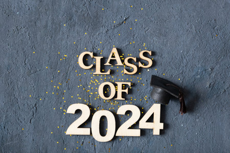 Class of 2024 concept. Number 2024 with graduated cap and confetti on dark background.の写真素材