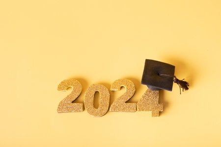 Golden glitter number 2024 with graduated cap. Class of 2024 concept