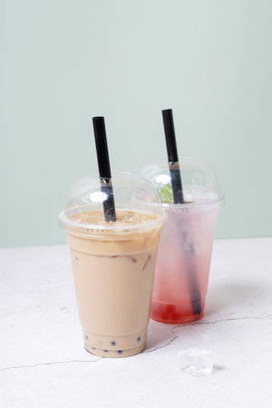 Two plastic glasses with bubble tea. Trendy summer drink with tapioca bubbles.の写真素材