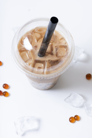 Plastic glass with bubble tea and ice. Trendy summer drink on white background.の写真素材