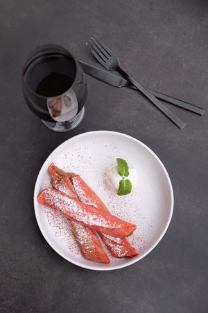 Plate with sweet pink pancakes and ice cream with coffee glass top view on dark backgroundの写真素材