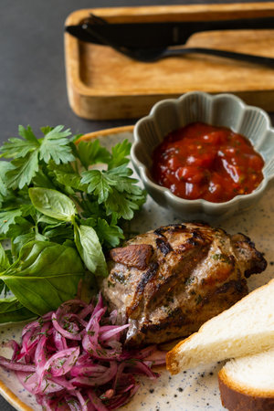 Plate of fried pork meat with tomato sauce and greens. Meat dishの写真素材