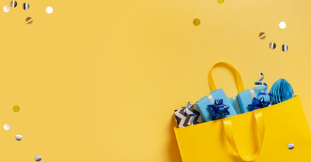 Yellow package with Christmas gifts. Festive flatlay with place for textの写真素材