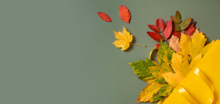 Autumn shopping and sales concept banner. Composition of autumn fallen leaves and shopping bag.